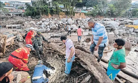  ?? LUIS ROBAYO / AFP ?? Los equipos de rescate intentan encontrar a personas con vida entre los restos de la avalancha en la ciudad amazónica