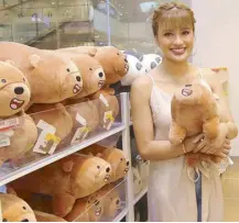  ??  ?? Singer and actress Julie Anne San Jose hugs her favorite We Bare Bears plush toy at the opening of Miniso’s 60th branch at SM Aura Premier.