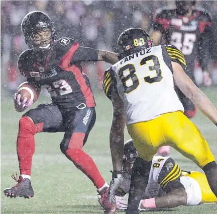  ?? WAYNE CUDDINGTON ?? Forrest Hightower avoids a tackle after intercepti­ng a pass in the first half of Friday night’s game at TD Place.