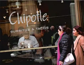  ?? Scott Olson Getty Images ?? CHIPOTLE MEXICAN GRILL recently hired former Taco Bell chief Brian Niccol as chief executive, a move both praised and scorned. Above, diners eat at a Chipotle restaurant in Chicago in October.