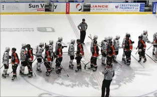  ?? NEWS PHOTO JAMES TUBB ?? The Medicine Hat Tigers meet the Red Deer Rebels at centre ice after losing Game 5 5-2 Friday at Co-op Place, losing their first-round series 4-1.