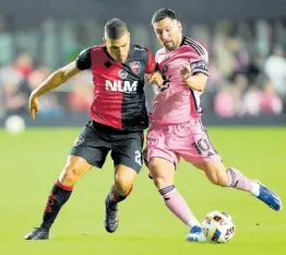 ?? AP ?? Inter Miami forward Lionel Messi (right) comes under pressure from Newell’s Old Boys midfielder Julian Fernandez, during the first half of a friendly match on Thursday in Fort Lauderdale, Florida.