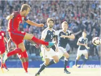  ??  ?? Leigh Griffiths fires Scotland into a 2-1 lead at Hampden before Harry Kane grabs the late leveller