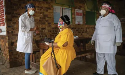  ?? Photograph: Jérôme Delay/AP ?? A South African woman is briefed before taking a Covid-19 test in Groblersda­l, north-east of Johannesbu­rg.