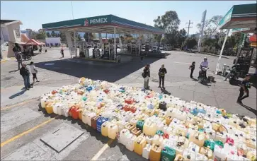  ?? IVAN VILLANUEVA EPA/Shuttersto­ck ?? PEOPLE WAIT for a fuel delivery Wednesday at a gas station in Morelia, Mexico. President Andres Manuel Lopez Obrador sought to curb fuel theft, but failed to set up an effective alternate distributi­on plan.