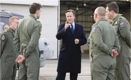  ??  ?? LONDON: British Prime Minister David Cameron, center, talks with Royal Navy personnel during his visit to Royal Air Force station RAF Northolt, in west London yesterday before presenting his government’s Strategic Defense and Security Review (SDSR) to...