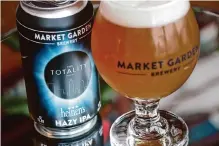  ?? Danni Haseley/associated Press ?? Cleveland-based Market Garden Brewery has partnered with grocery chain Heinen’s to sell cans of hazy IPA called “The Totality,” shown in this photo, ahead of the total solar eclipse.