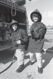  ?? ?? Youngsters got the chance to dress up as firefighte­rs at an open day in 1977. Ref:134834-5