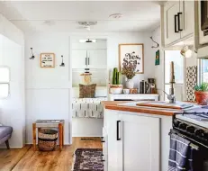  ??  ?? White units make the tiny kitchen look roomy; the three children love their snug bunk beds shoehorned into a space outside the bathroom