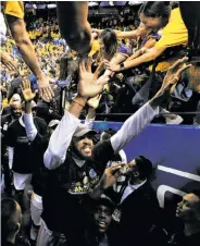  ?? Carlos Avila Gonzalez / The Chronicle ?? JaVale McGee, who celebrates with fans as he walks toward the locker room, is about to go Hollywood.