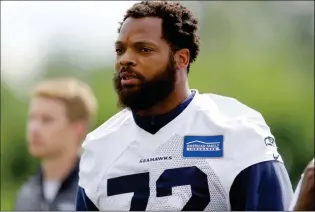  ?? ASSOCIATED PRESS ?? IN THIS JUNE 13 FILE PHOTO, Seattle Seahawks defensive end Michael Bennett walks off the field following practice in Renton, Wash. Bennett says he will sit during the national anthem this season to protest social injustice and segregatio­n. Bennett sat...