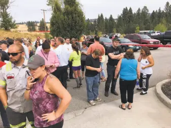  ?? Dan Pelle / Associated Press ?? Parents gather in the parking lot behind Freeman High School in Rockford, Wash., to wait for their children after a shooting at the school left one student dead and three others injured.