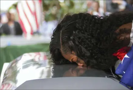  ?? MATIAS J. OCNER, THE ASSOCIATED PRESS ?? Myeshia Johnson kisses the casket of her husband, Sgt. La David Johnson Saturday during his burial service at in Hollywood, Fla. Myeshia Johnson told ABC’s “Good Morning America” on Monday that she has nothing to say to the president.