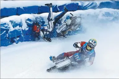  ?? SHAMIL ZHUMATOV / REUTERS ?? Harald Simon of Austria crashes next to Dinar Valeev of Russia during Astana Expo FIM Ice Speedway Gladiators World Championsh­ip in Almaty, Kazakhstan, last week.