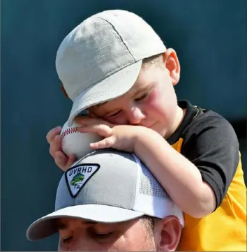 ?? Matt Freed/Post-Gazette ?? DREAMS OF SUMMER Pirates fan Paxton Larson, 2, of Clarion, falls asleep on his father’s shoulders as they wait for autographs Tuesday at Pirate City in Bradenton, Fla.