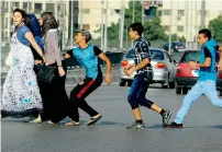  ?? AP file ?? An Egyptian youth, trailed by his friends, gropes a woman crossing the street with her friends in Cairo, Egypt, In August, 2012. —