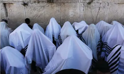  ??  ?? Ultra-Orthodox Jews pray in front of the Western Wall in Jerusalem last month. The man is accused of raising his family in an ultraOrtho­dox community despite being a Christian missionary. Photograph: Abir Sultan/EPA