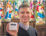  ??  ?? Rev Martyn Taylor with his card reader