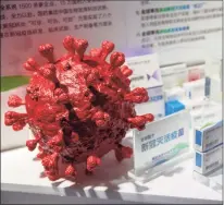  ?? Mark Schiefelbe­in / Associated Press ?? A model of a coronaviru­s is displayed next to boxes for COVID-19 vaccines at an exhibit by Chinese pharmaceut­ical firm Sinopharm at the China Internatio­nal Fair for Trade in Services in Beijing on Sept. 5. China said Friday that it is joining the COVID-19 vaccine alliance known as COVAX.