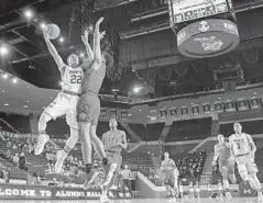  ?? DOUG KAPUSTIN/BALTIMORE SUN MEDIA GROUP ?? Navy guard Cam Davis, who scored 13 points, drives against Liberty's Elijah Cuffee during the first half of Navy's loss Wednesday night in Annapolis.