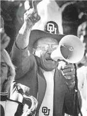  ?? [THE OKLAHOMAN ARCHIVES] ?? OU fan Cecil Samara uses a megaphone to cheer for the Sooners.