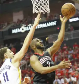  ?? GETTY IMAGES ?? The Rockets’ Chris Paul shoots against the Warriors’ Klay Thompson on Thursday. Paul left the game in the final minute after injuring his right hamstring.