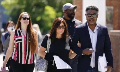  ??  ?? Former NFL players Ken Jenkins, right, and Clarence Vaughn III, center right, along with their wives, Amy Lewis, center, and Brooke Vaughn, left, carry tens of thousands of petitions demanding equal treatment for everyone involved in the settlement of concussion claims against the NFL, to the federal courthouse in Philadelph­ia on Friday. Photograph: Matt Rourke/AP