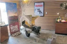  ?? MIKHAIL ILIEV/THE ASSOCIATED PRESS ?? The wood chipper used in the movie Fargo is on display at the FargoMoorh­ead Visitors Center in Fargo, N.D. Right: Vases inspired by the Red River made by artist John Offutt at the Underbrush Gallery.