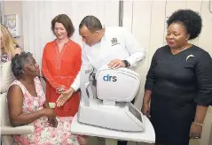  ??  ?? Health Minister Dr Christophe­r Tufton (second right) speaks with Maria Wheatle (left), a patient at the Greater Portmore Health Centre in St Catherine, prior to her eyes being tested for diabetic retinopath­y in the facility’s newly opened screening room. Looking on (from second left) are chief executive of the Queen Elizabeth Diamond Jubilee Trust, Dr Astrid Bonfield; and regional director, South East Regional Health Authority, Maureen Golding. The screening room for diabetic retinopath­y was opened during a ceremony last week, at which the Diabetic Retinopath­y Screening Programme was officially launched.