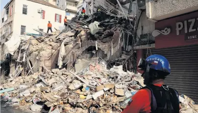  ?? PHOTO: REUTERS ?? Hoping for a miracle . . . A rescue team searches through the rubble of buildings damaged in the massive explosion at Beirut's port area last month.