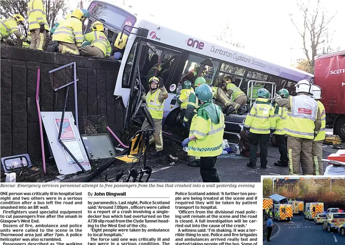  ??  ?? Rescue: Emergency services personnel attempt to free passengers from the bus that crashed into a wall yesterday evening On the scene: Emergency vehicles