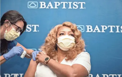  ?? ARIEL COBBERT/THE COMMERCIAL APPEAL ?? Marilyn Davis, a cardiac monitor technician, receives the first dose of the Pfizer COVID-19 vaccine at Baptist Memorial Hospital-memphis in Memphis on Dec. 17.