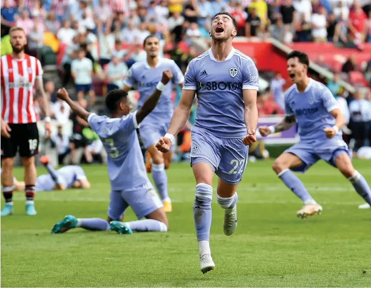  ?? ?? Cracker Jack: Harrison roars with delight as his stoppage-time goal seals victory for Leeds to spark joyous celebratio­ns among his team-mates, with boss Jesse Marsch on the floor (right) and fans congratula­ting Brazilian Raphinha (top)