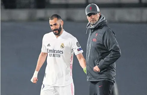  ?? AFP ?? Liverpool manager Juergen Klopp, right, congratula­tes Real Madrid forward Karim Benzema after their Champions League quarter-final first leg last week.