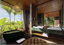  ?? Photos Gdas Bali ?? The flower-filled bathtub overlookin­g fields and awaiting guests on arrival is a notable highlight