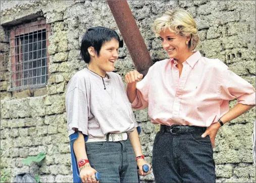  ?? AP FILE PHOTO ?? In this photo from 1997, Britain’s Diana, Princess of Wales (right) chats with 15-year-old landmine victim Bosnian muslim girl Mirzeta Gabelic, in front of Mirzeta’s home in Sarajevo, while Diana was on a visit to the region as part of her campaign...