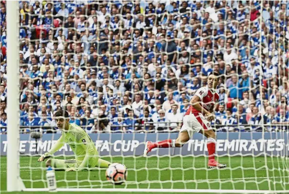  ?? 2-1. — AP ?? No Cup joy: Arsenal’s Alexis Sanchez scoring past Chelsea goalkeeper Thibaut Courtois during the FA Cup final at Wembley in May 27, 2017. Arsenal won