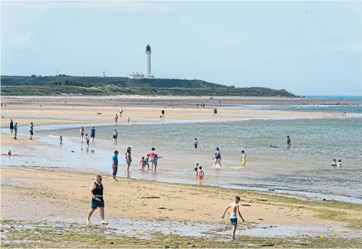  ??  ?? SCORCHER: Sun-lovers enjoying the hot weather on Lossiemout­h West Beach, Moray, which was the warmest place in Scotland yesterday