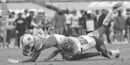  ?? ERIN EDGERTON/ASSOCIATED PRESS ?? Virginia wide receiver Lavel Davis Jr. (81) is tackled by North Carolina State cornerback Shyheim Battle (25) during Saturday’s Wolfpack victory.