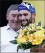  ?? CHRISTOPHE ENA — THE ASSOCIATED PRESS ?? Stage winner and new overall leader Fernando Gaviria of Colombia celebrates with former cyclist and Tour de France winner Eddy Merckx on the podium with after the first stage of the Tour de France cycling race Saturday.