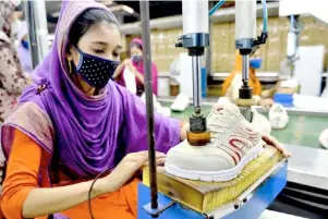  ?? XINHUA ?? WORKERS make shoes at the factory of Panda Shoes Industries Ltd. in Gazipur on the outskirts of Dhaka, Bangladesh.