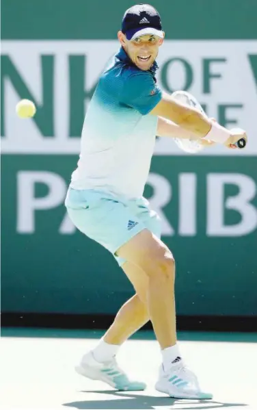  ??  ?? Dominic Thiem returns a shot to Milos Roanic during the semi-finals at the Indian Wells on Saturday.