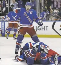  ??  ?? New York Rangers captain Ryan McDonagh skates in the join the celebratio­n with Carl Hagelin, who scored the goal in overtime that eliminated the Penguins from the playoffs in the first round.
