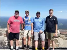  ?? ?? Black Elk Peak is South Dakota’s highpoint. Mark Burd, left, Hayden Burd, Garrett Burd and Andrew Claudy have been traveling together to reach all of the state highpoints and currently have bagged 35 of 50.