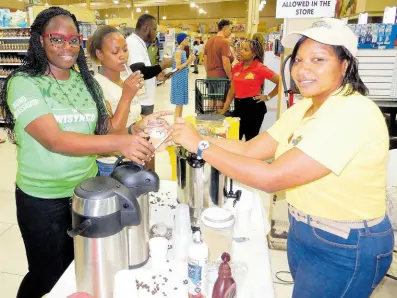  ?? PHOTOS BY CARL GILCHRIST ?? Tameka Pinnock (right), of Nakashka Coffee Company, producers of Moy Hall Estate Coffee, serves another sampling of the beverage during a promotion in Ocho Rios, St Ann, recently.