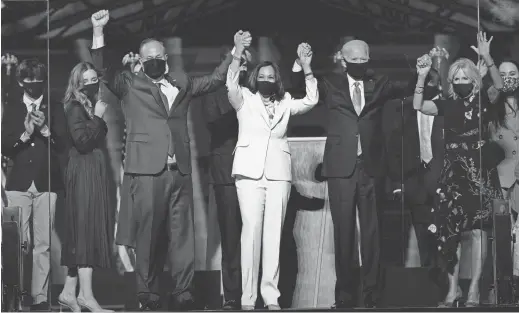  ?? AP ?? From left, Doug Emhoff, husband of Vice President-elect Kamala Harris; Harris; President-elect Joe Biden and his wife, Jill, on Saturday in Wilmington, Del.