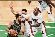  ?? Kathryn Riley / Getty Images ?? The Celtics’ Jayson Tatum drives to the basket against the Heat’s Max Strus in Friday’s Game 6 of the Eastern Conference finals.