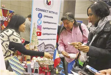  ??  ?? The Philippine booth at the 7th Annual Embassy Showcase Winternati­onal features crafts and festive treats from all over the country (top). Cultural attaché Lalie Gavino shows guests some Filipino Christmas ornaments.