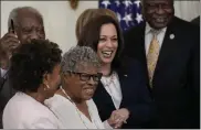  ?? DREW ANGERER / GETTY IMAGES ?? Activist and retired educator Opal Lee, 94, center, known as the Grandmothe­r of Juneteenth, holds hands with Vice President Kamala Harris as President Biden signs the Juneteenth National Independen­ce Day Act into law at the
White House on Thursday.