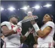  ?? RUSTY COSTANZA — THE ASSOCIATED PRESS ?? Alabama quarterbac­k Jalen Hurts, right, and defensive lineman Da’Ron Payne (94) hold up the bowl trophy after defeating Clemson in the Sugar Bowl semifinal playoff game in New Orleans, Monday.